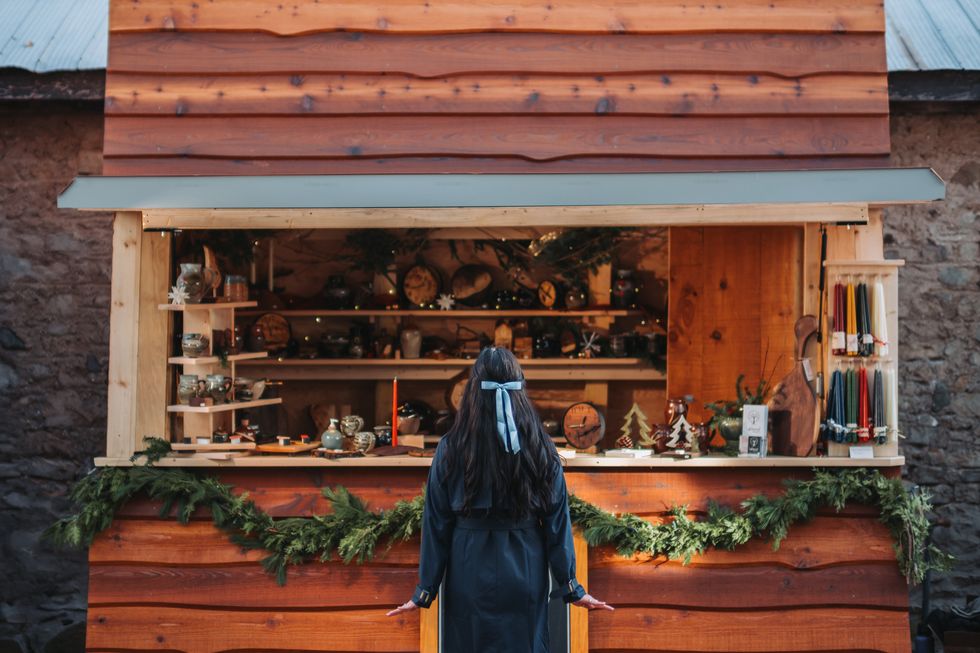 A person standing in a Christmas market.
