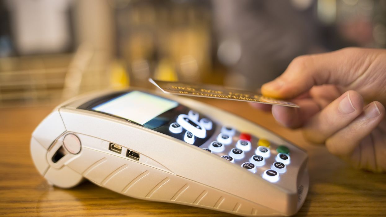 A person tapping their credit card.