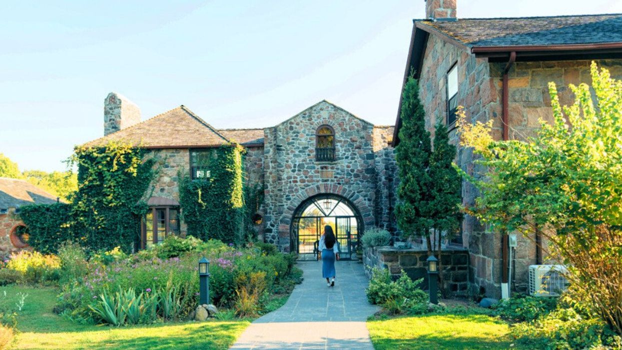 A person walking into a historic building.