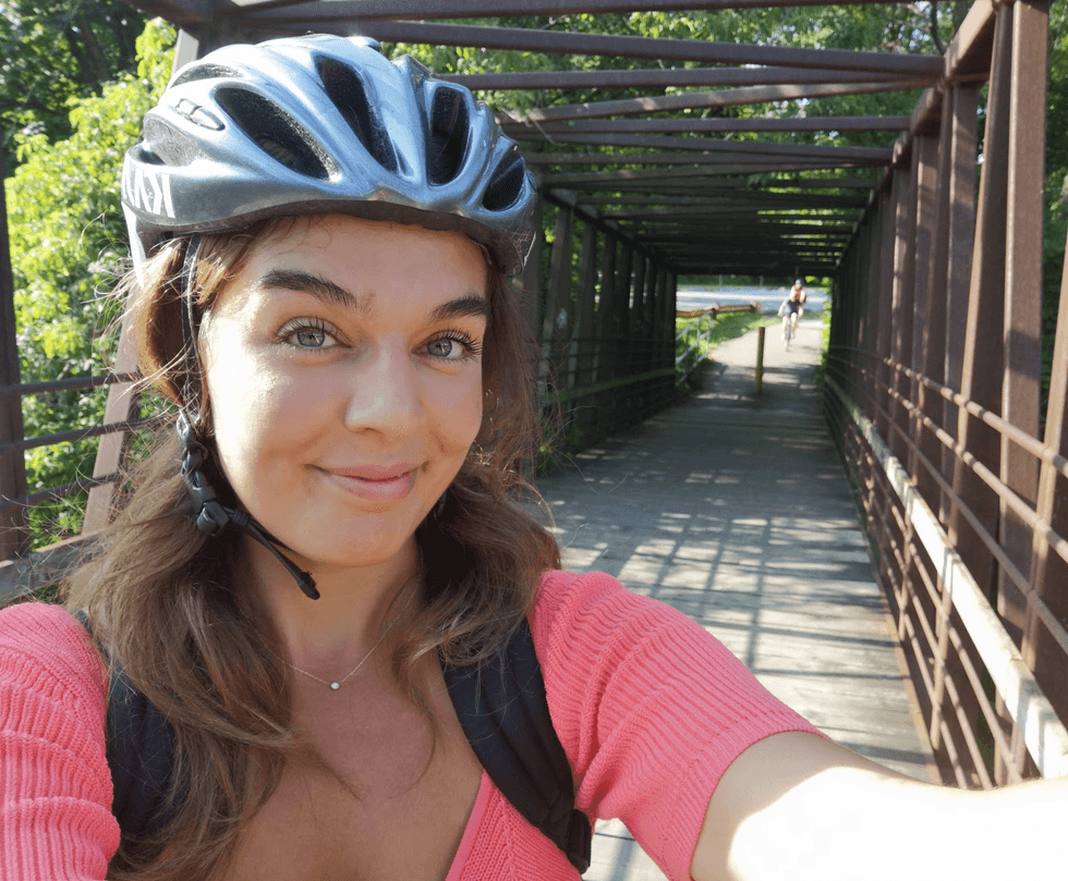 A person wearing a helmet on a bike path.