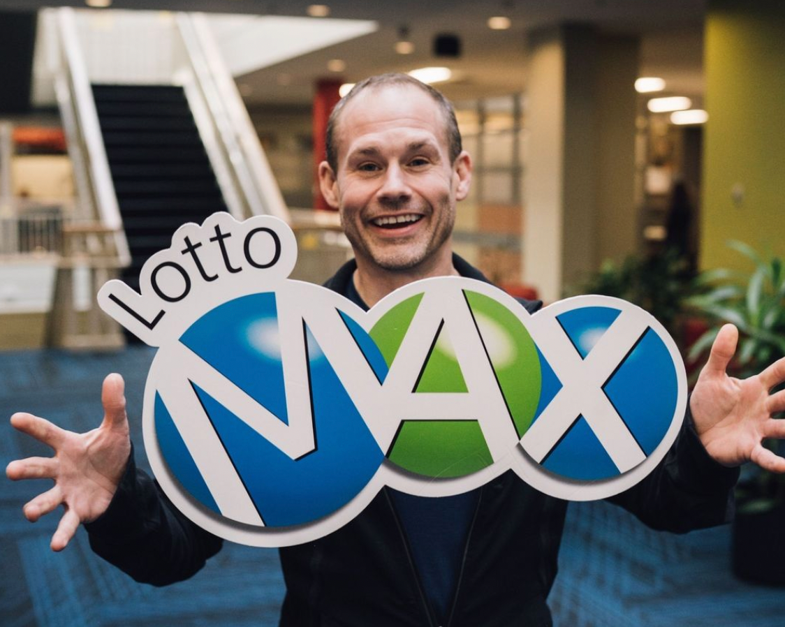 A person with a Lotto Max sign.