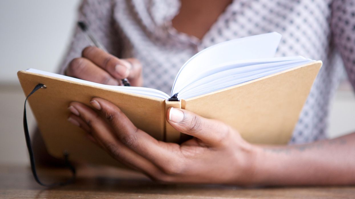 A person writing in a journal.