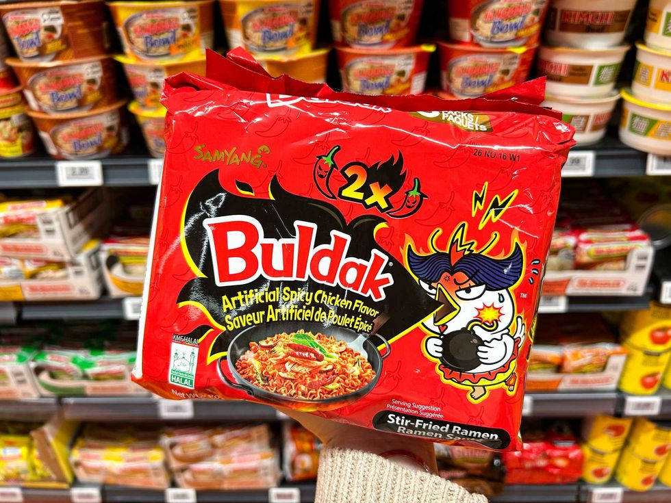 a photo of a packet of spicy chicken flavoured ramen in a grocery aisle