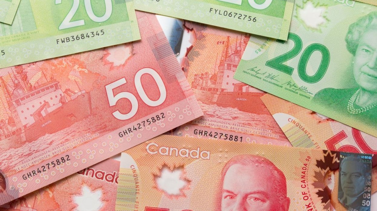 A pile of Canadian banknotes including several $50 and $20 bills.