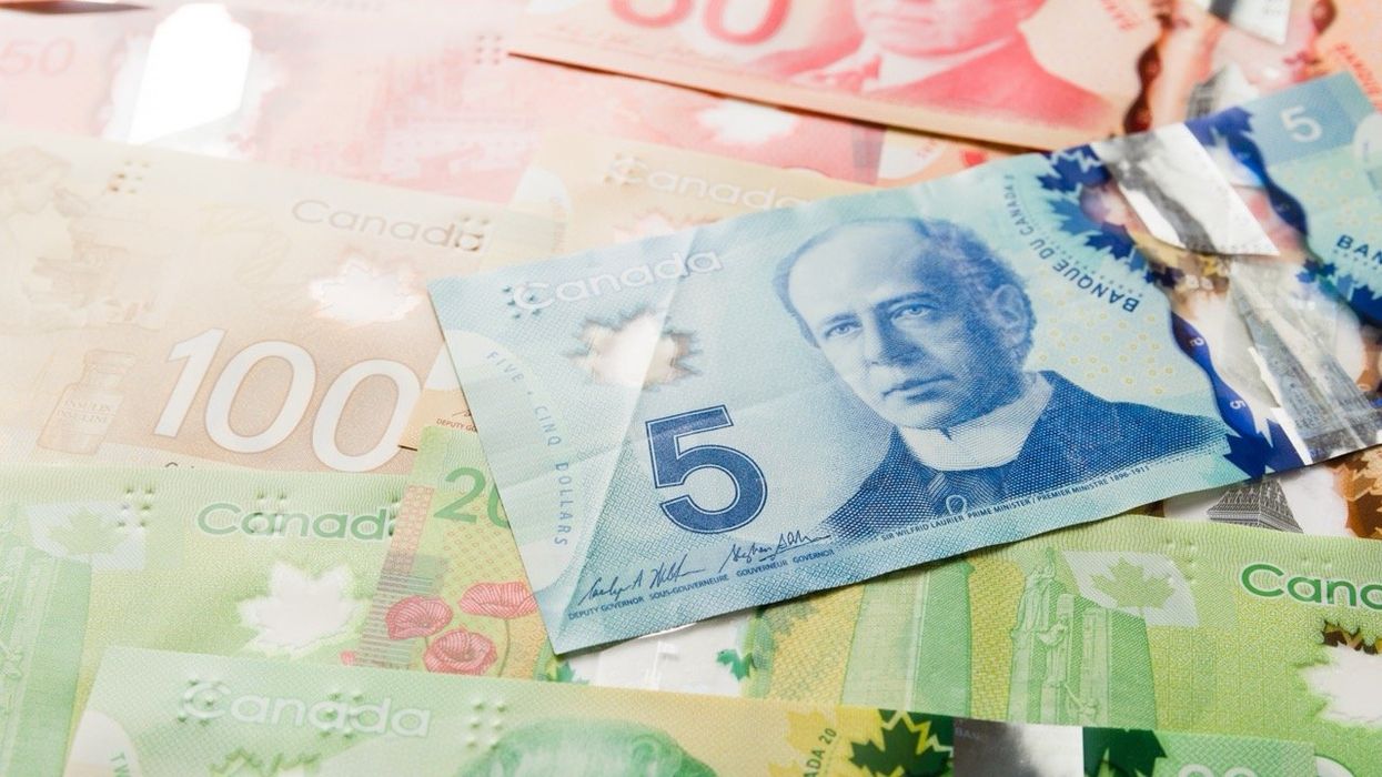 A pile of Canadian bills, including a $5 bill.