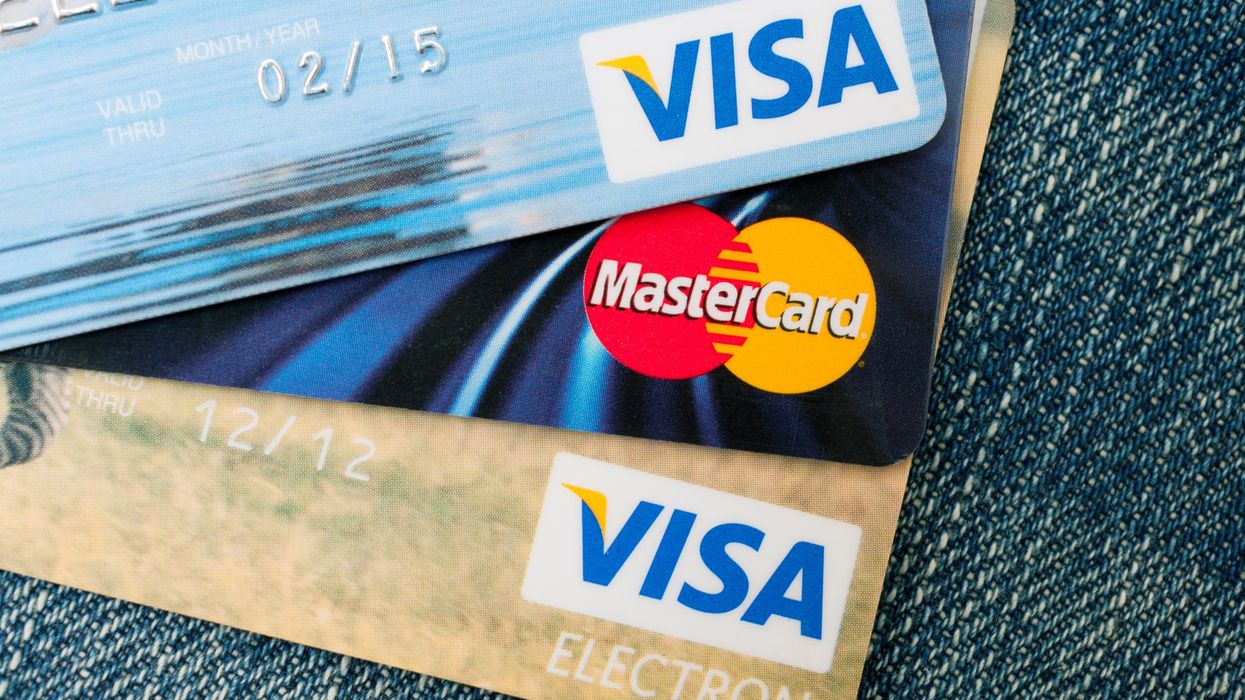 A pile of Visa and Mastercard credit cards.
