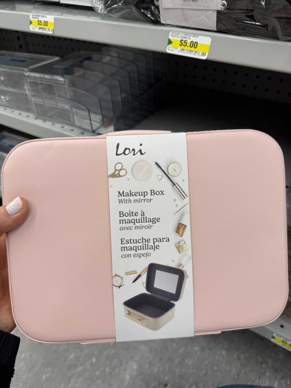 A pink box with a label showing the inside of it with makeup around it and a label that reads makeup box with mirror.