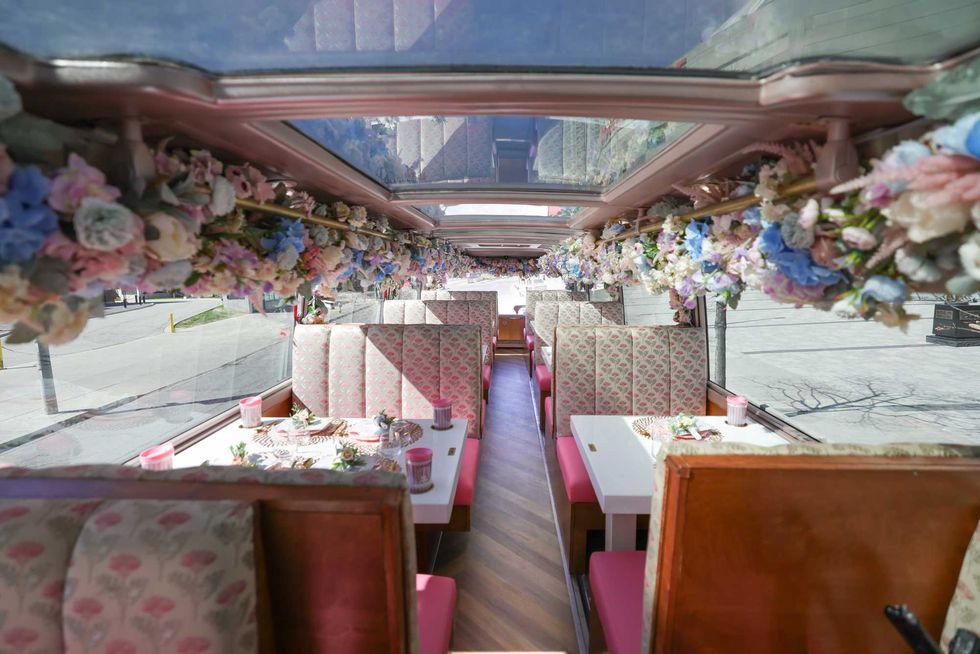 A pink bus interior with flowers.