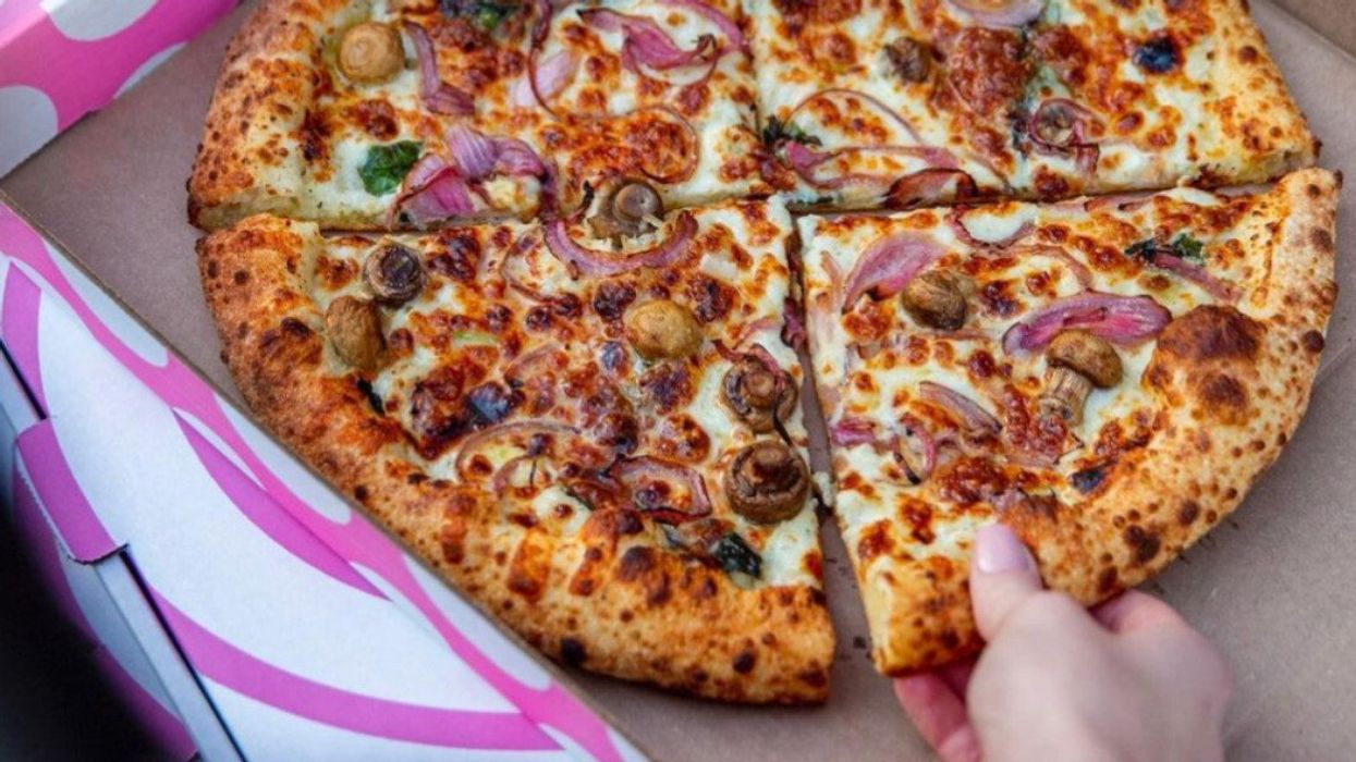 A pizza slice being pulled from a pizza box.