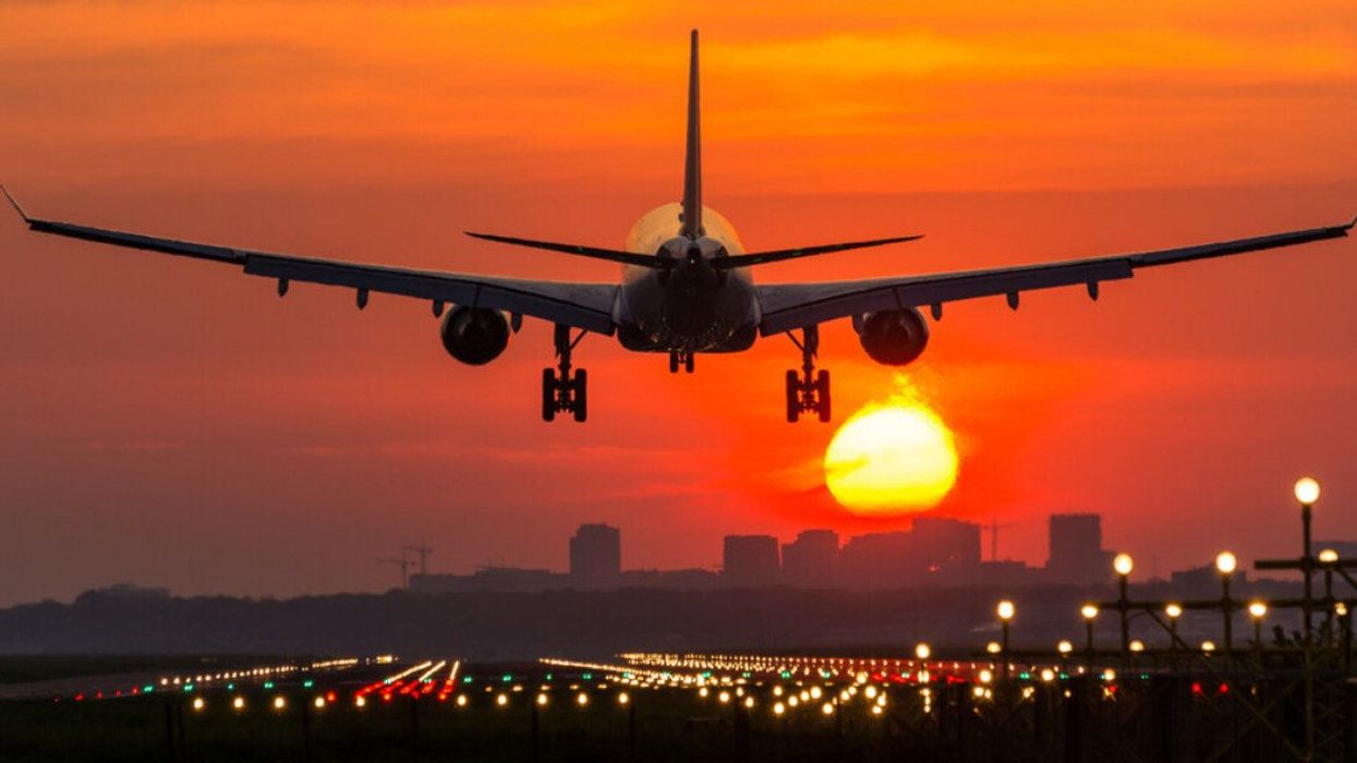 A plane landing at an airport.