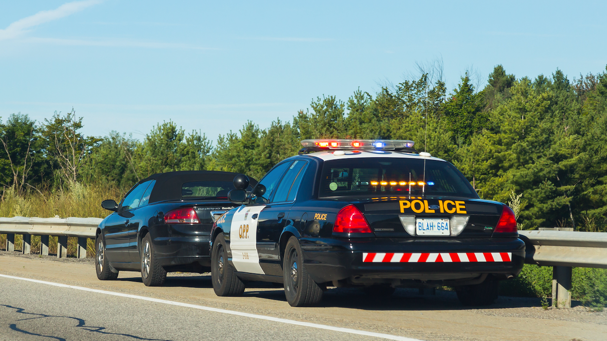 A police car pulls over a driver in Canada.