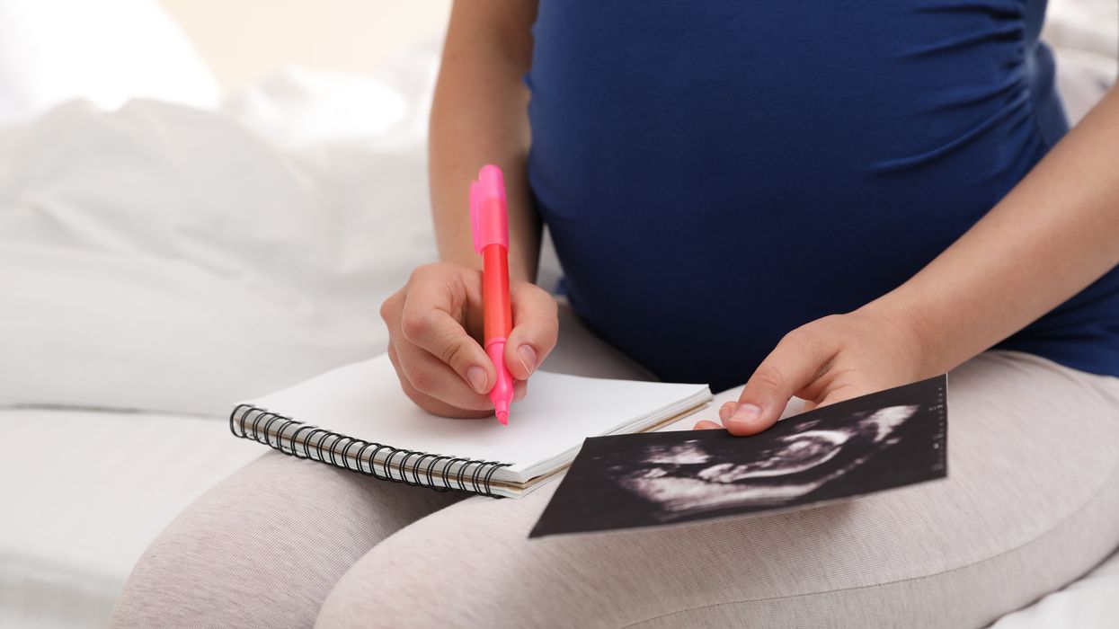 A pregnant woman thinking of a baby name.