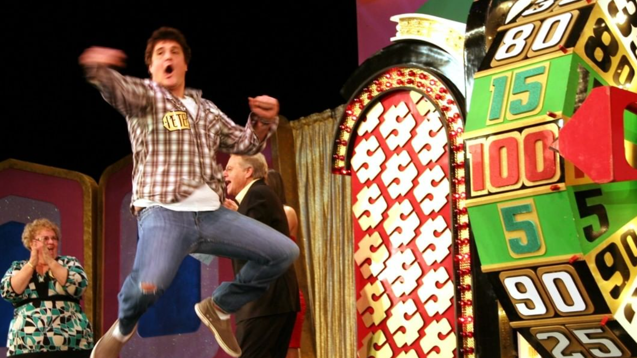 A Price Is Right Live contestant celebrating after spinning the wheel.