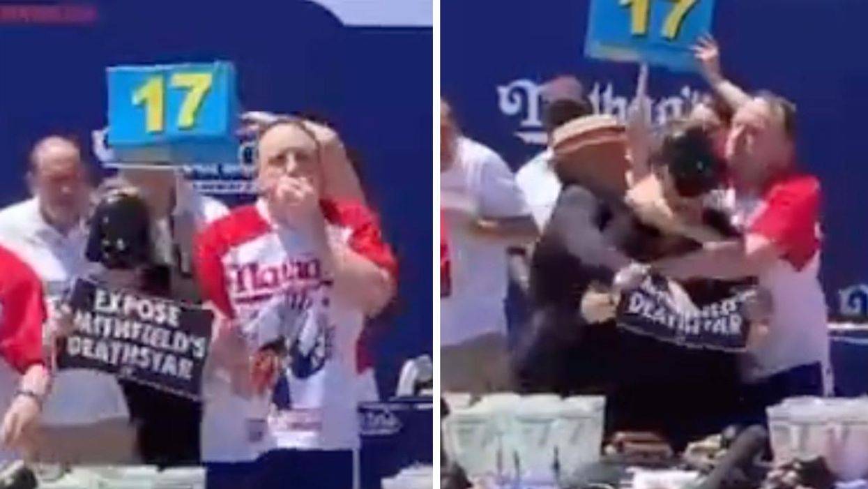 A protester interrupts Joey Chestnut during the Nathan's Famous Hot Dog Eating Contest.