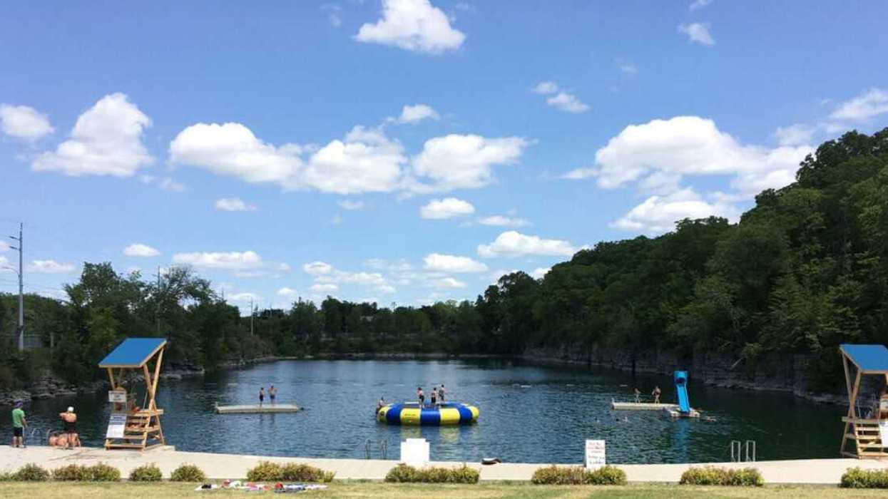 A quarry with a water trampoline and slide.