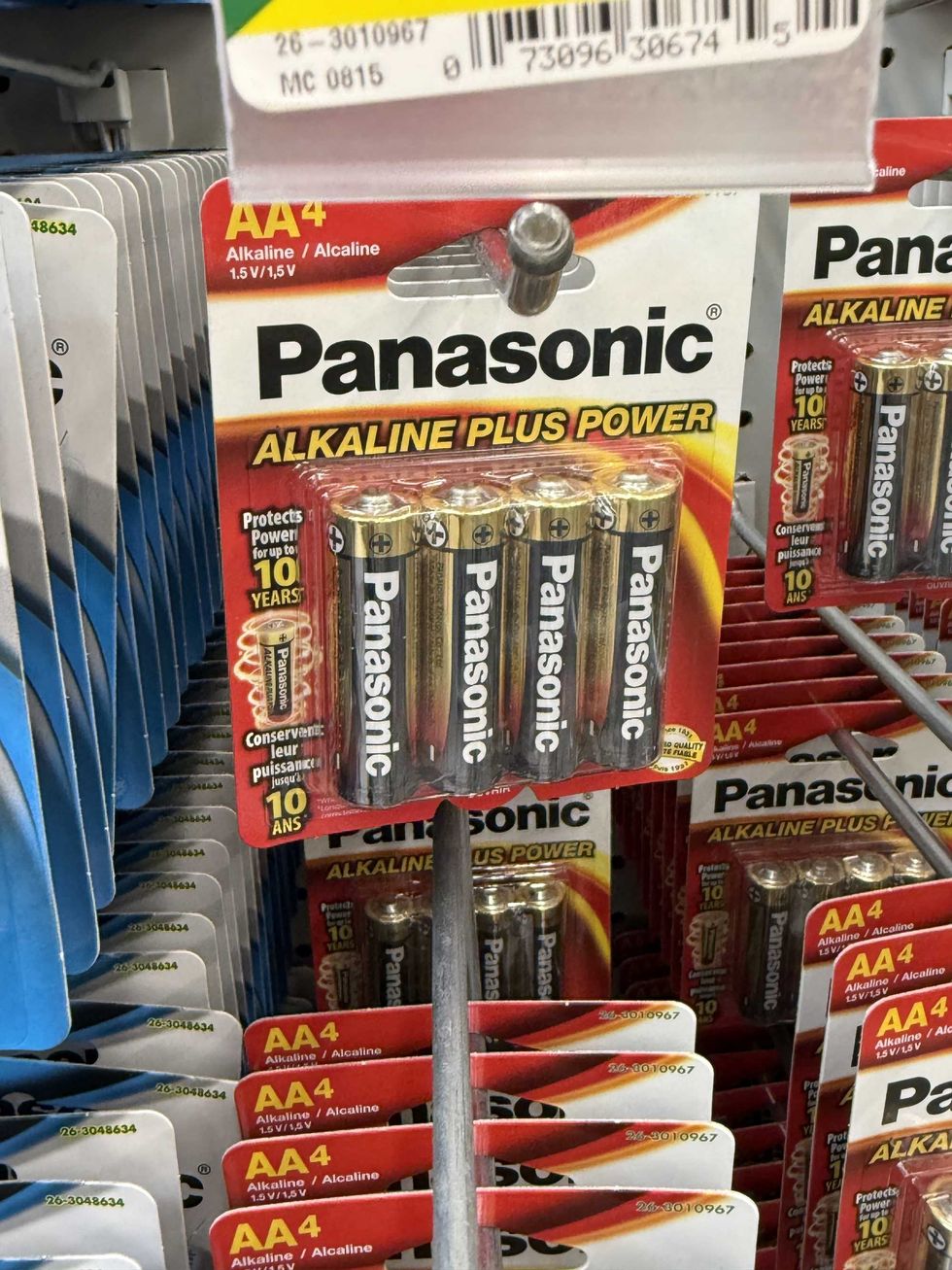A red and white pack of batteries on a store shelf.