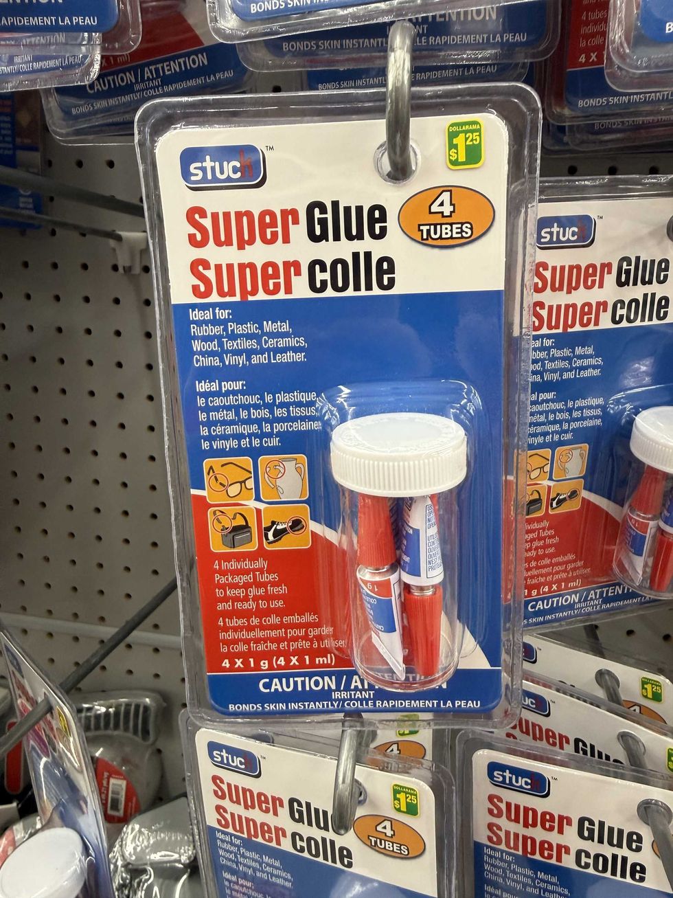 A red, blue and white package with a clear tub and four tubes inside that says Super Glue on them.