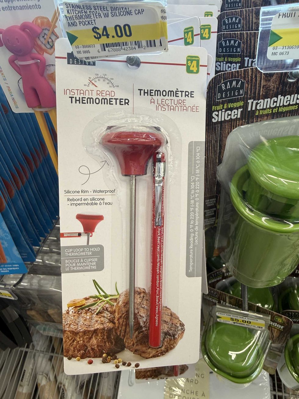 A red thermometer for cooking with a picture of meat on it.