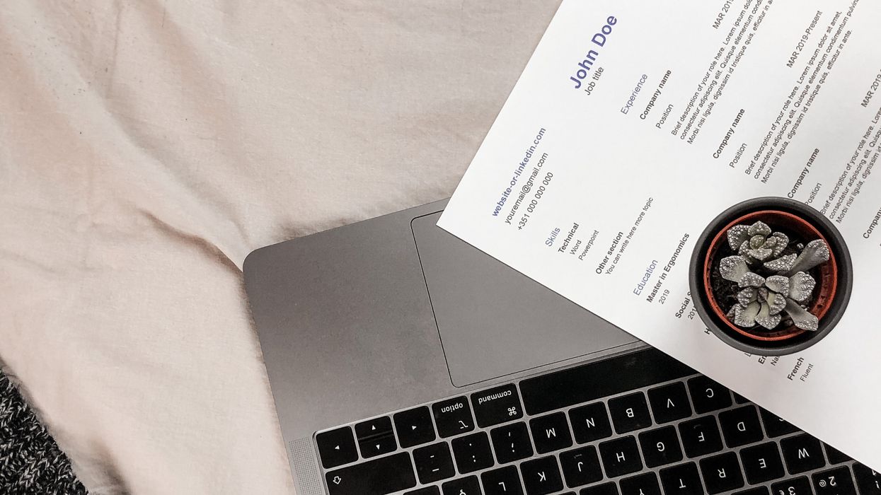 A resume on top of a computer.