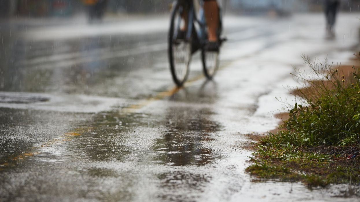 A road with rainy conditions and puddles.