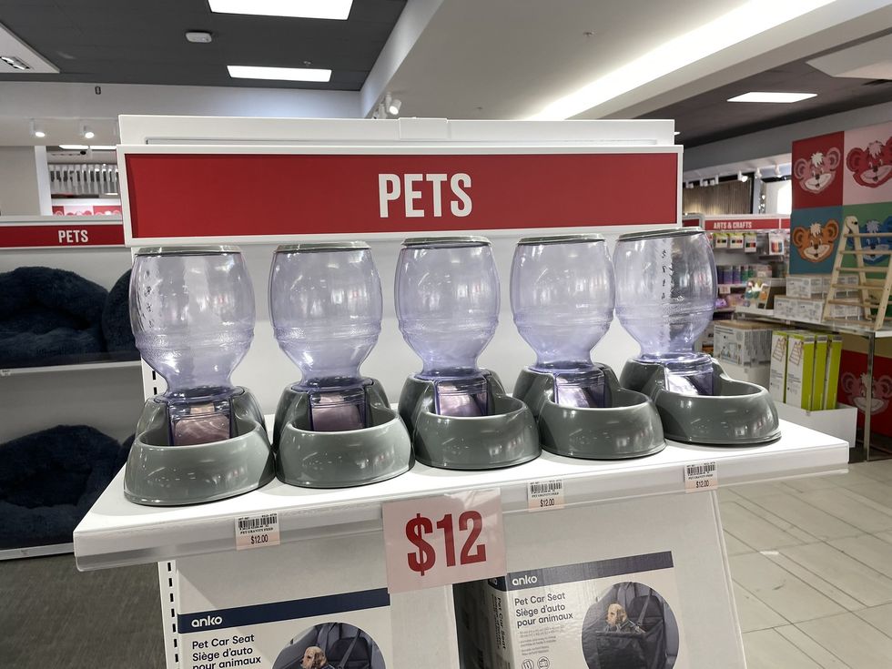 A row of pet food dispensers.
