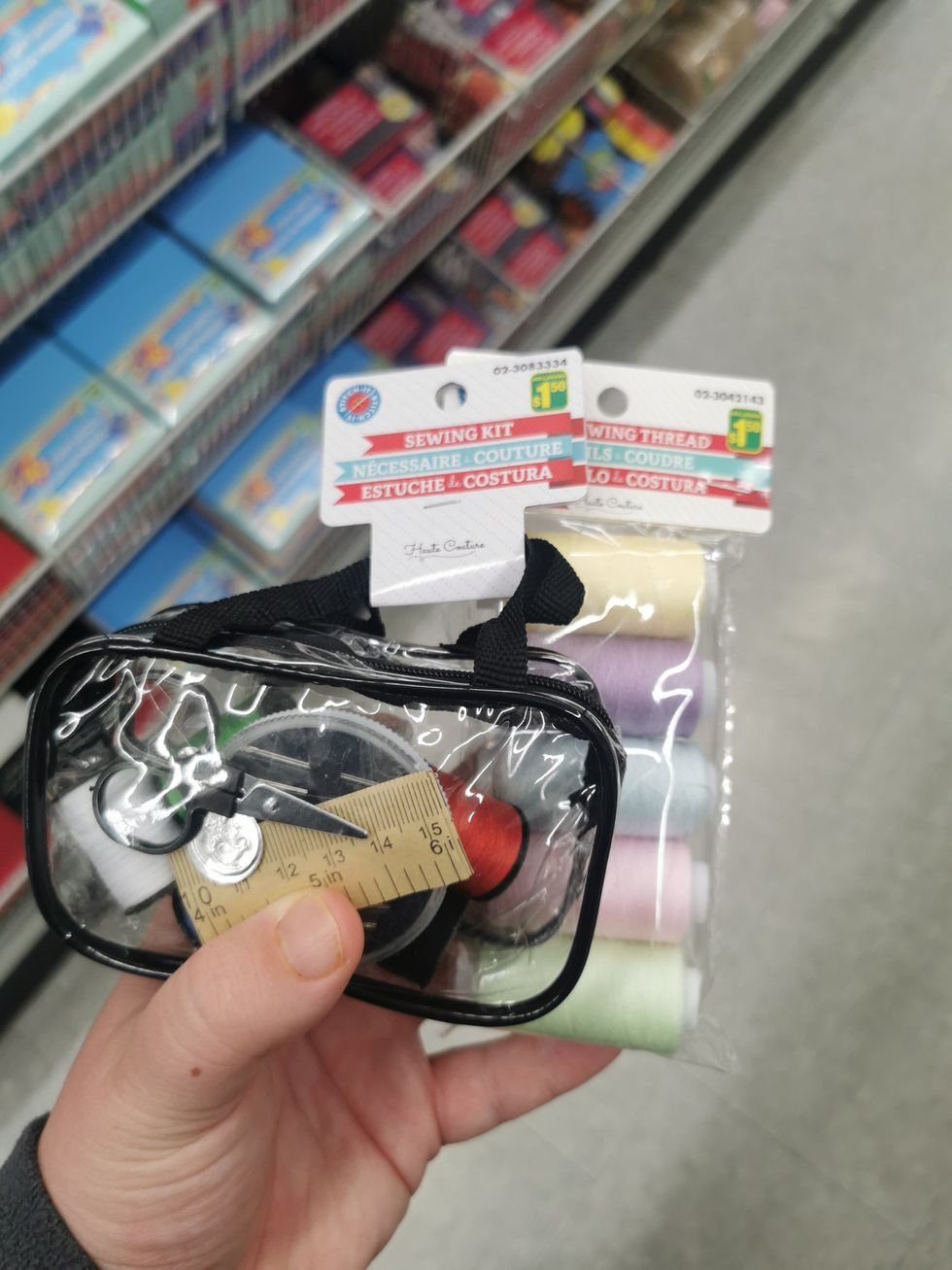 A sewing kit and sewing thread from Dollarama.