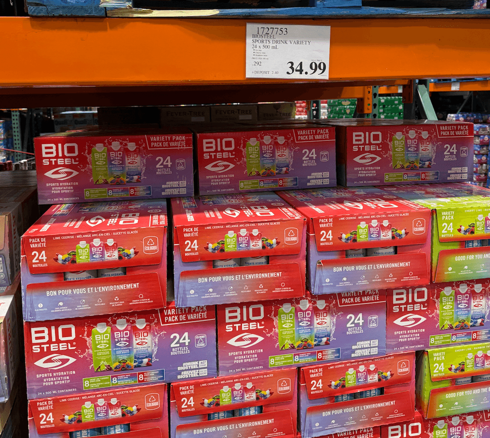A shelf full of sports drinks.