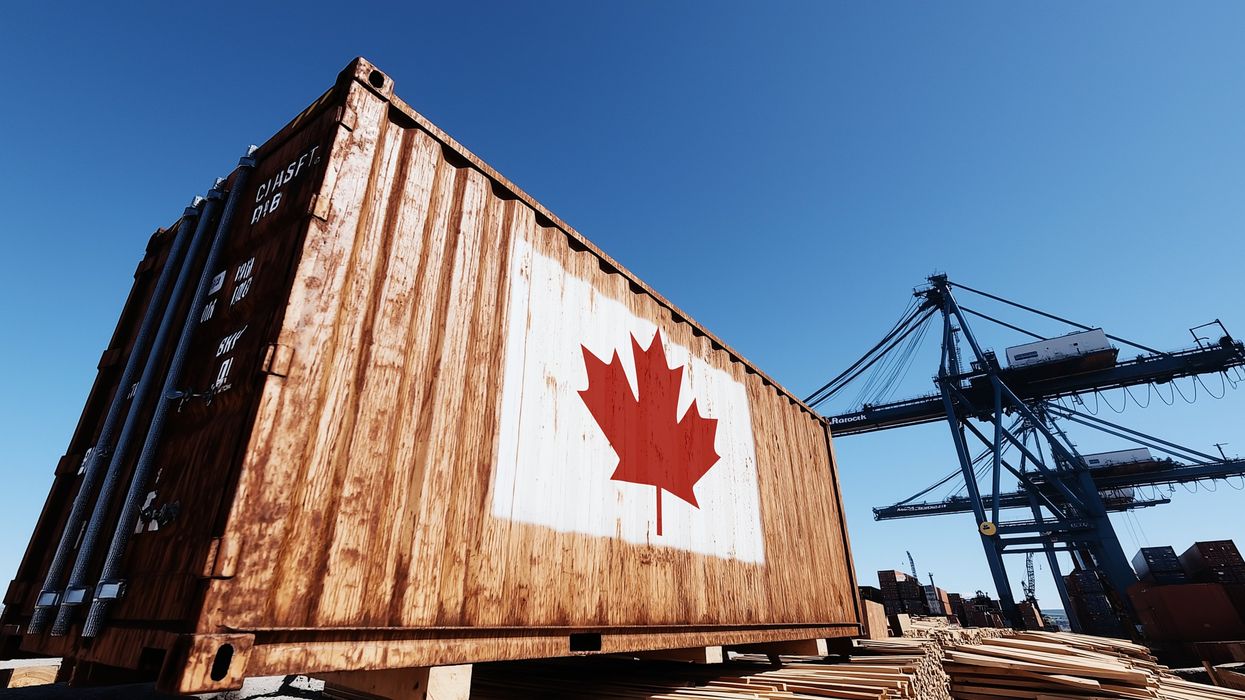 A shipping container with a painted maple leaf at a Canadian export facility.