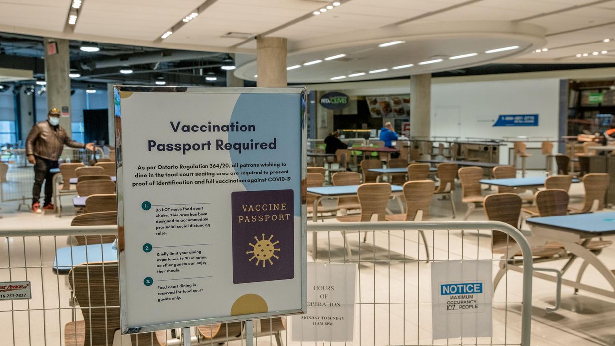 A sign showing a vaccine passport requirement in a Toronto foodcourt.