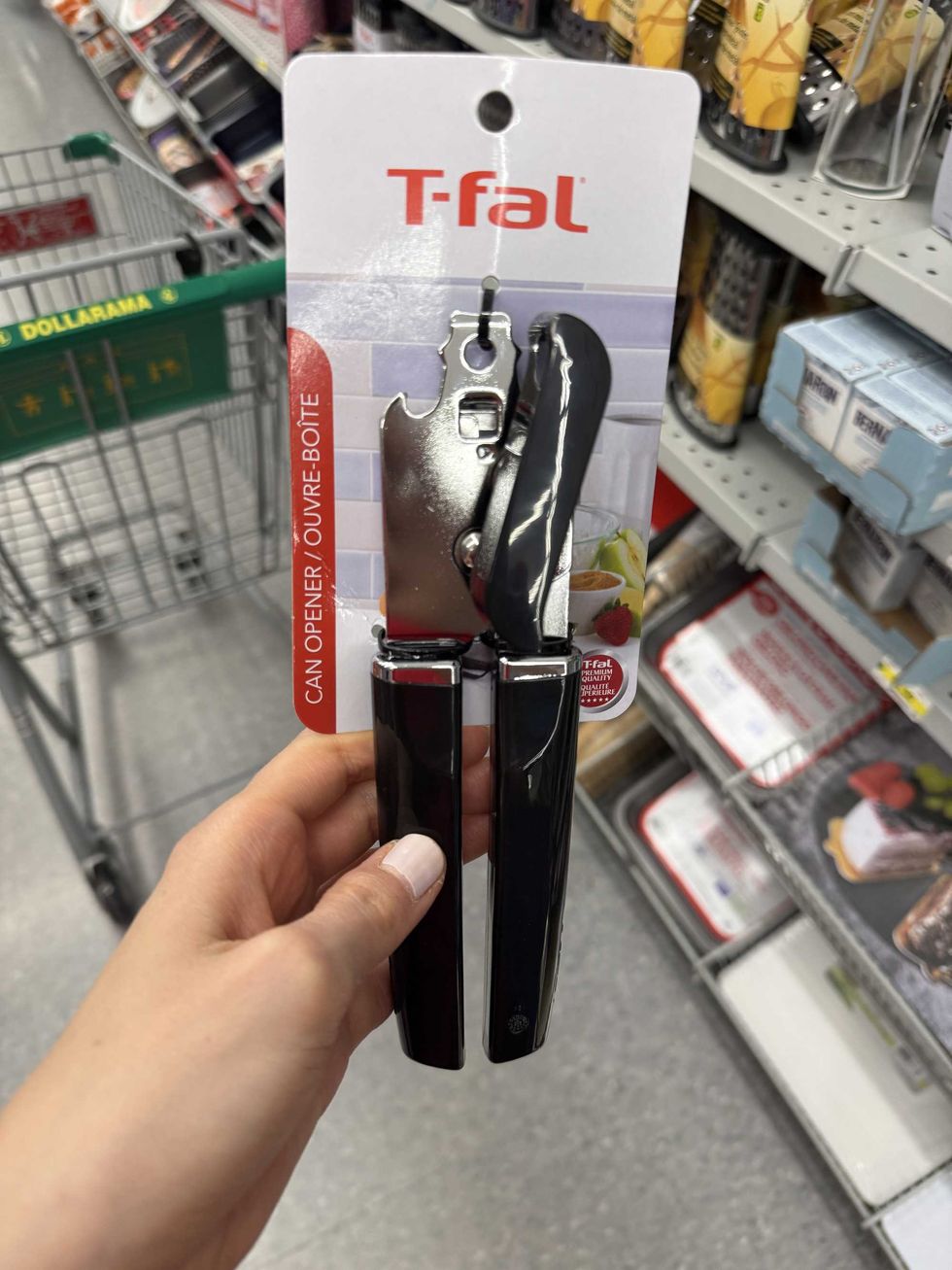 A silver and black tool with a label that says T-fal can opener.