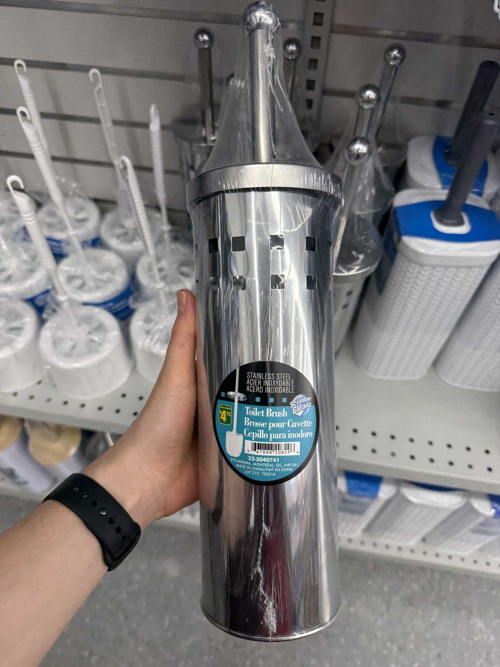 A silver-colored container that says toilet brush on the label.