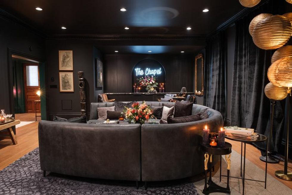 A sitting room decorated in dark colours.