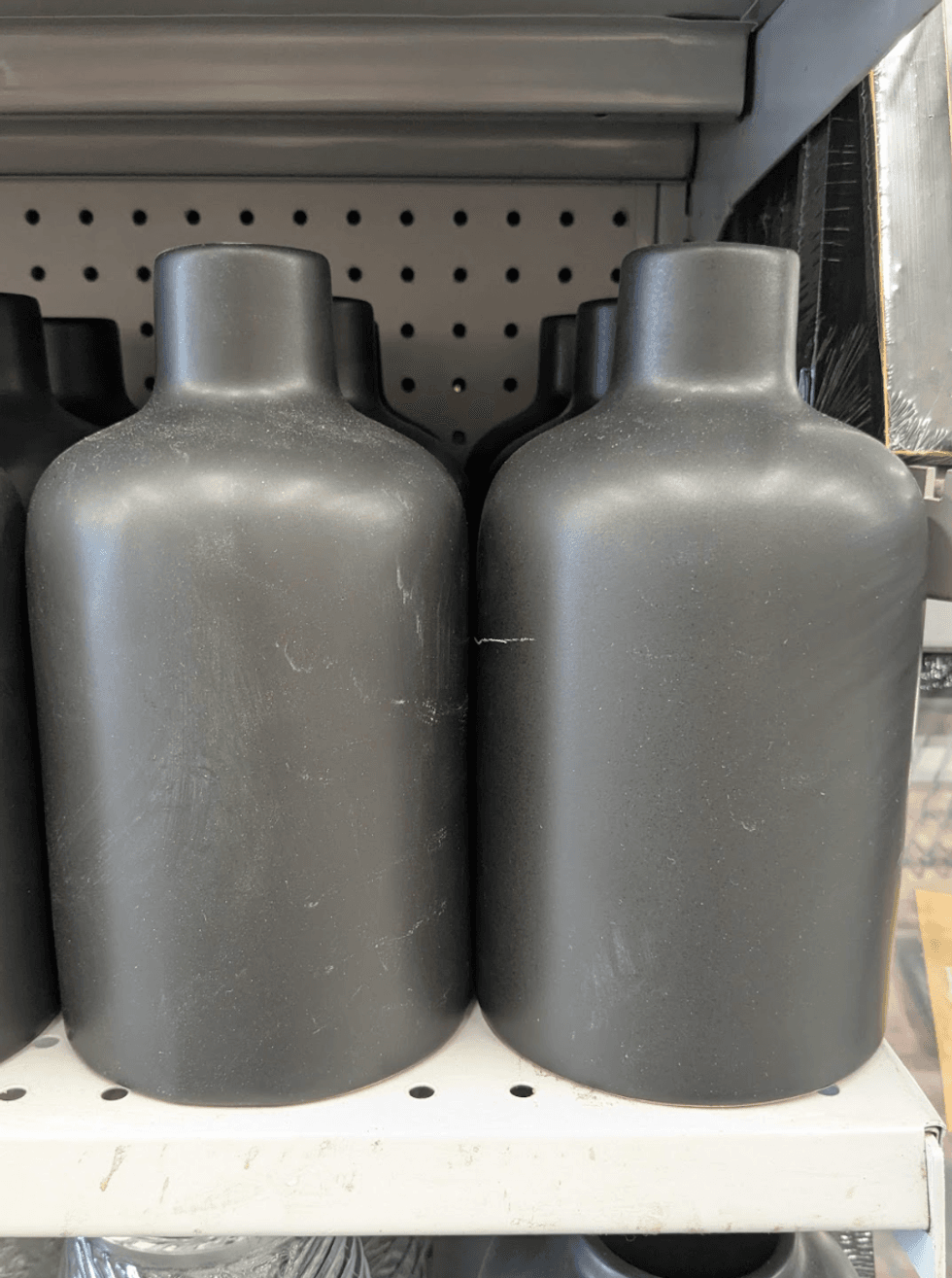 A small matte black stone-textured vase