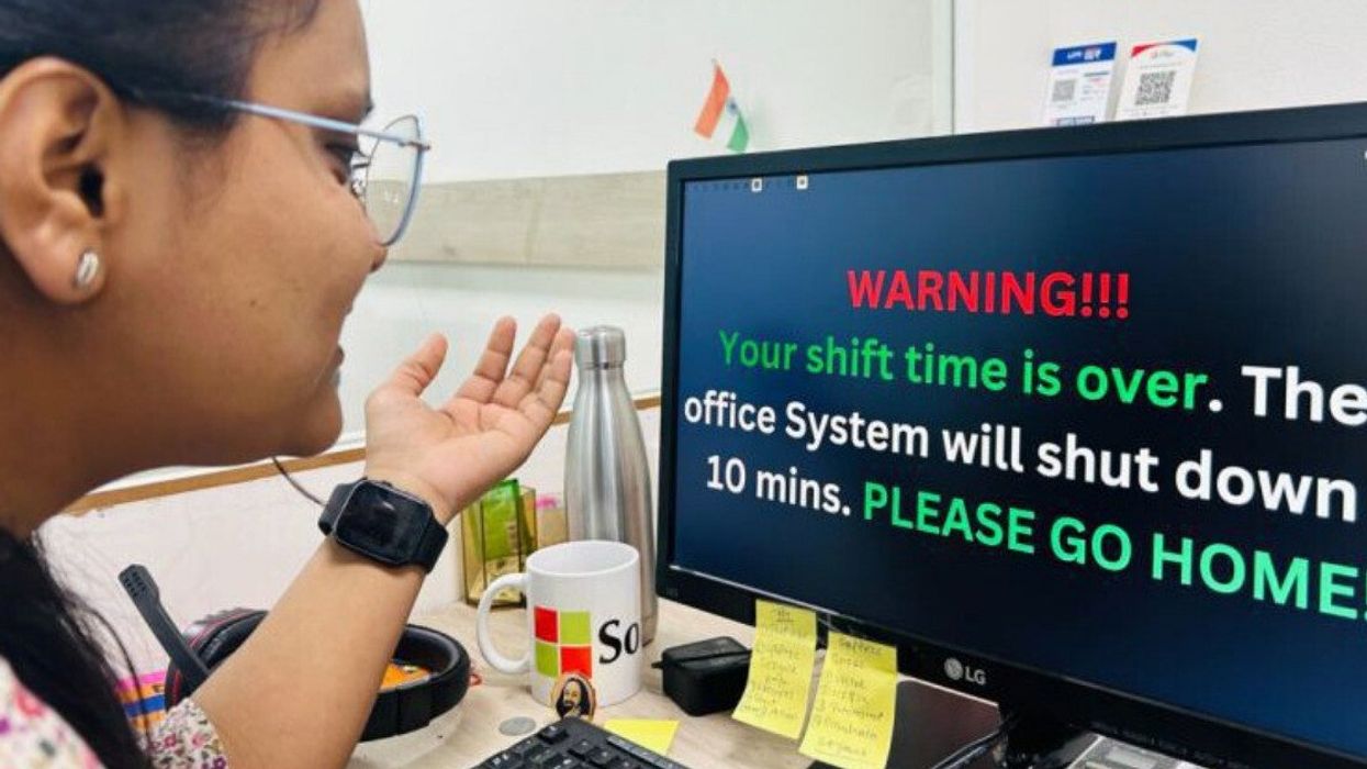 A SoftGrid Computers employee reacts to a message telling her to log off at the end of the day.