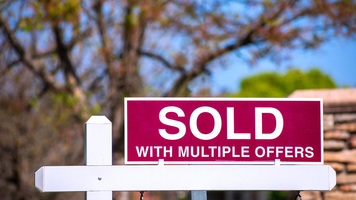 A 'SOLD with multiple offers' real estate sign.