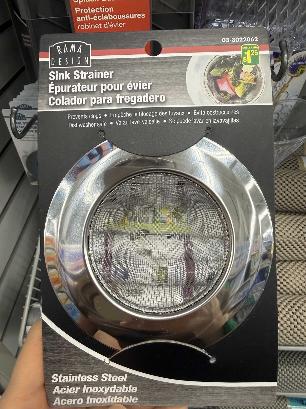 A stainless steel sink strainer with a store label on it.