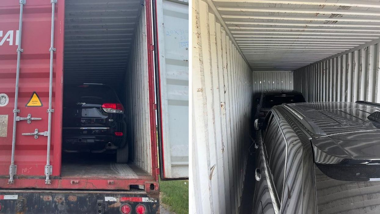 A stolen Jeep Cherokee and Range Rover in a shipping container.