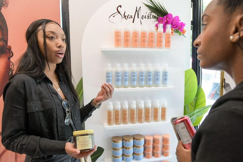 A stylist explains SheaMoisture products to a client.