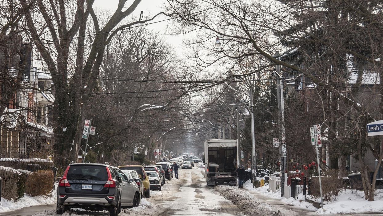 A suburban street in Toronto during a snowy afternoon.