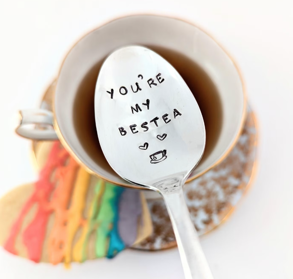 A teaspoon that says "your'e my bestea" with hearts and a tea mug on it.