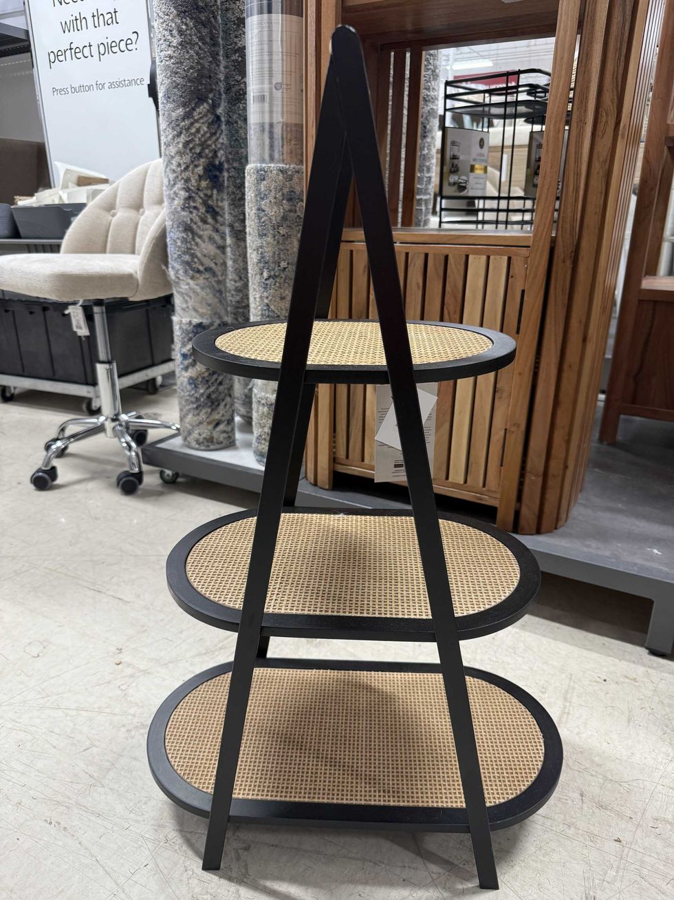 A three-tiered brown and black table at a store.