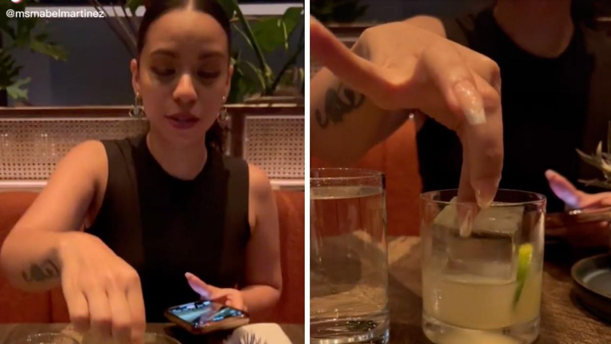 A TikToker touching the King cube in her rocks glass.