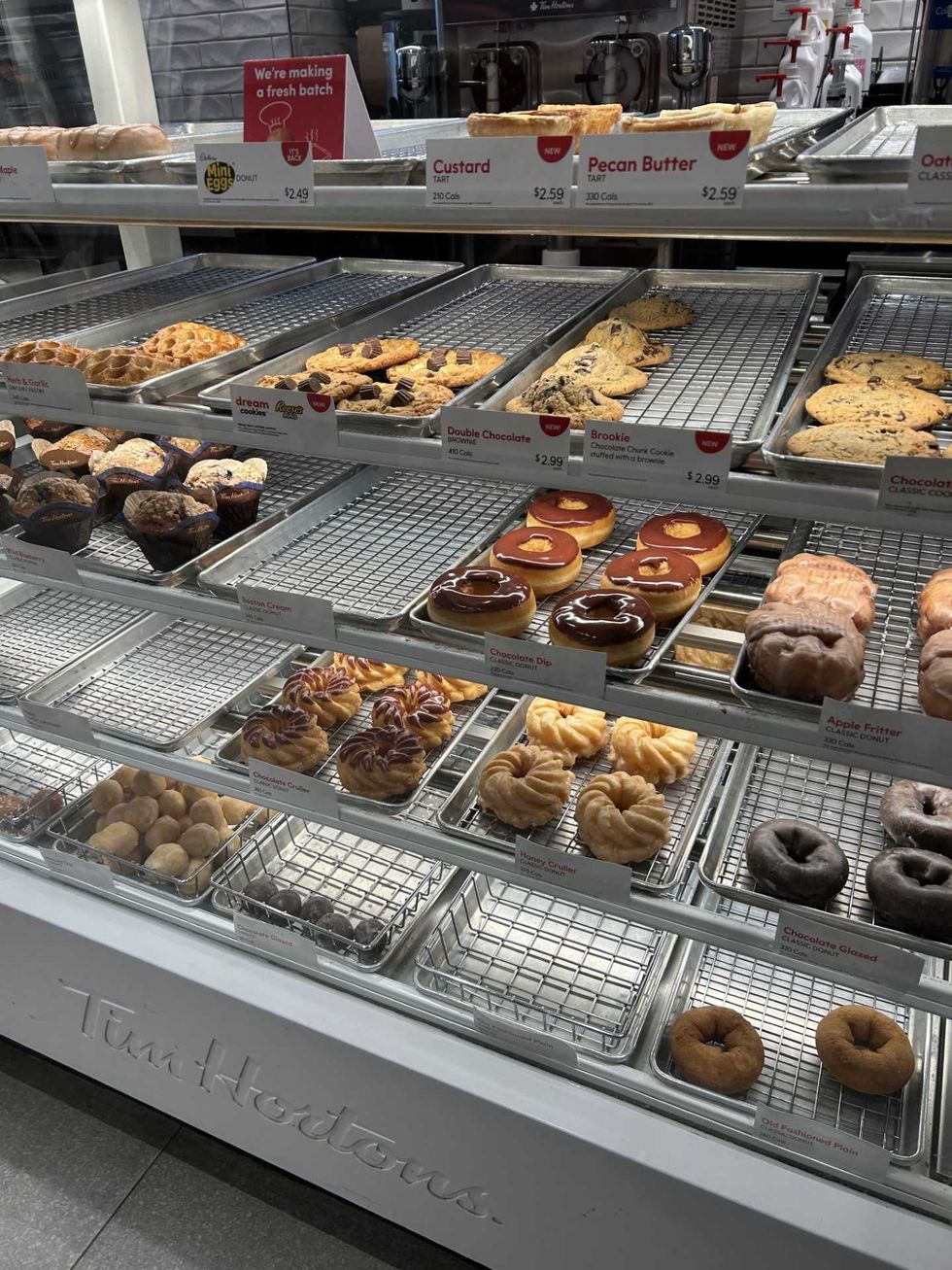 A Tim Hortons counter displaying cookies and donuts.