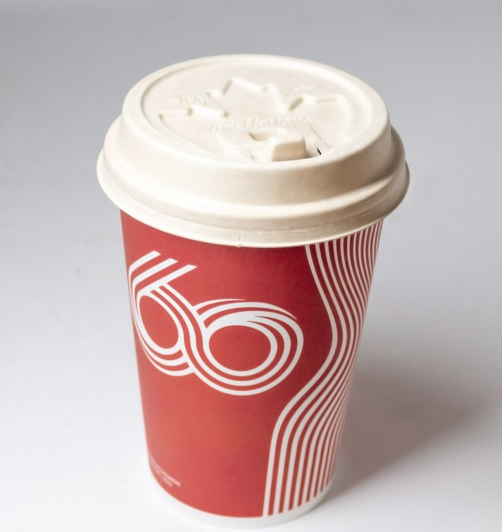 A Tim Hortons cup with a plastic-free and recyclable hot beverage lid.