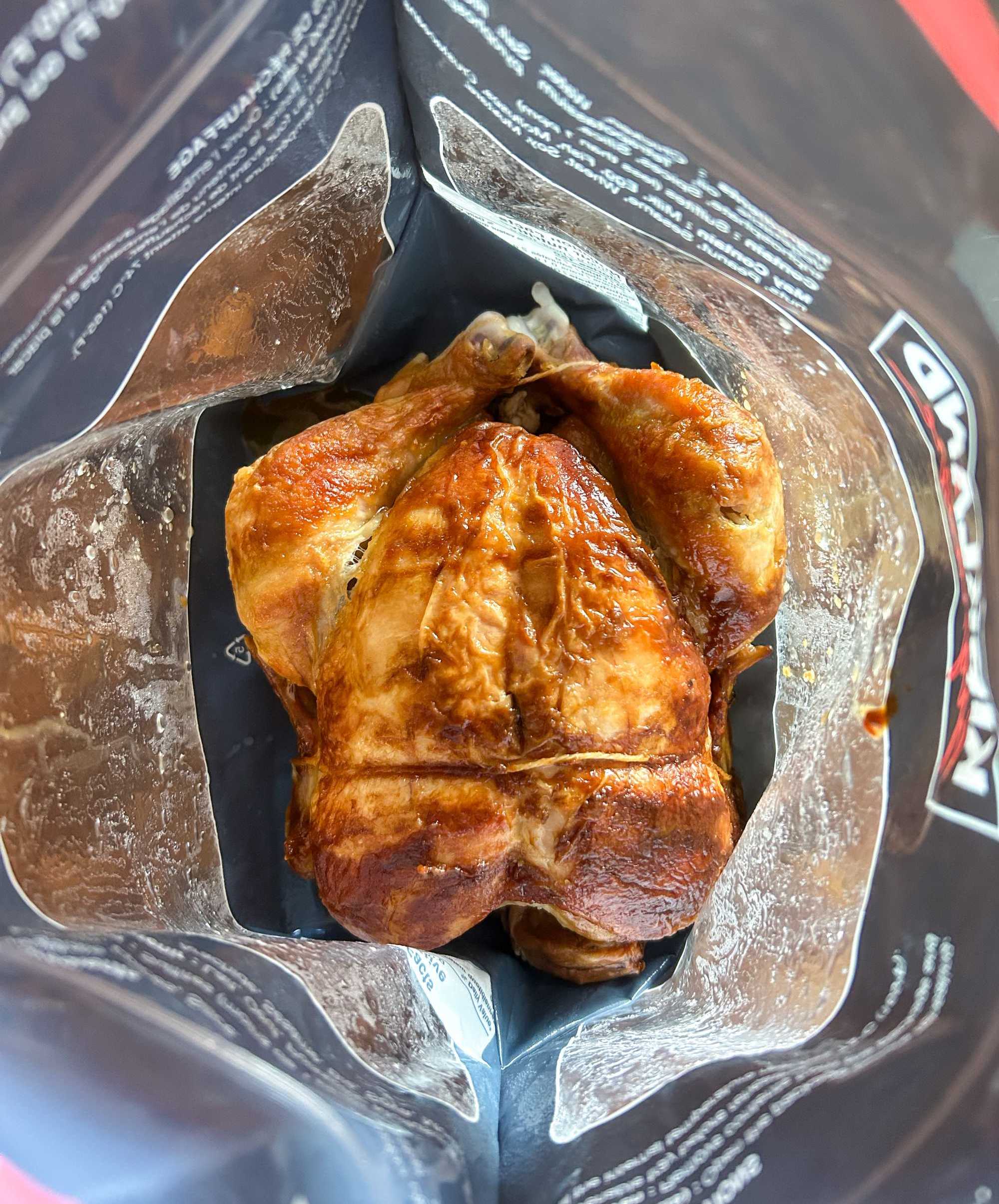 A top-down photo of a rotisserie chicken from Costco in a Kirkland bag