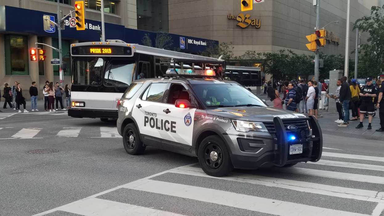 A Toronto police car drives through the street during Pride Month.