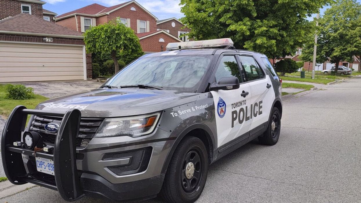 A Toronto police car parked outside a house.
