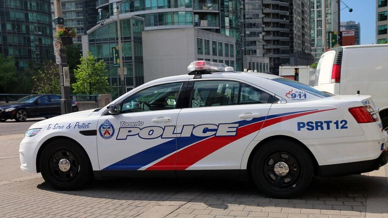 A Toronto Police cruiser parked on a sidewalk.