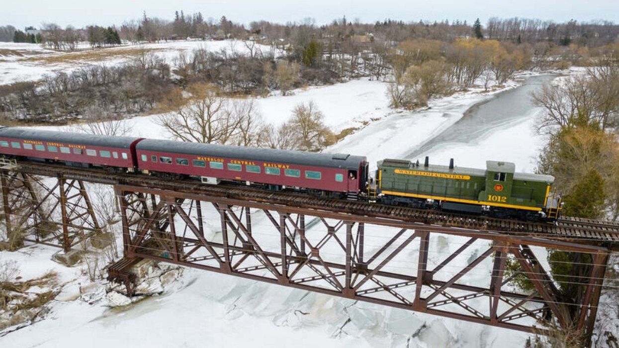 A train crossing a bridge during the winter.