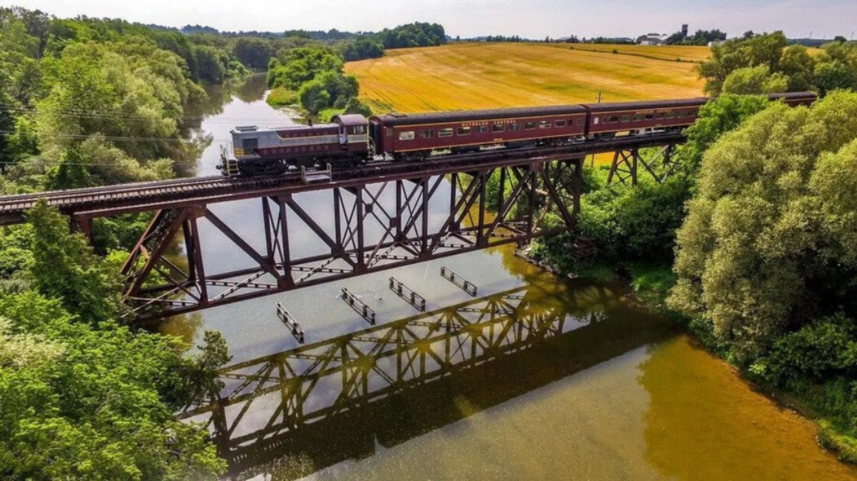A train crossing a river on a bridge.